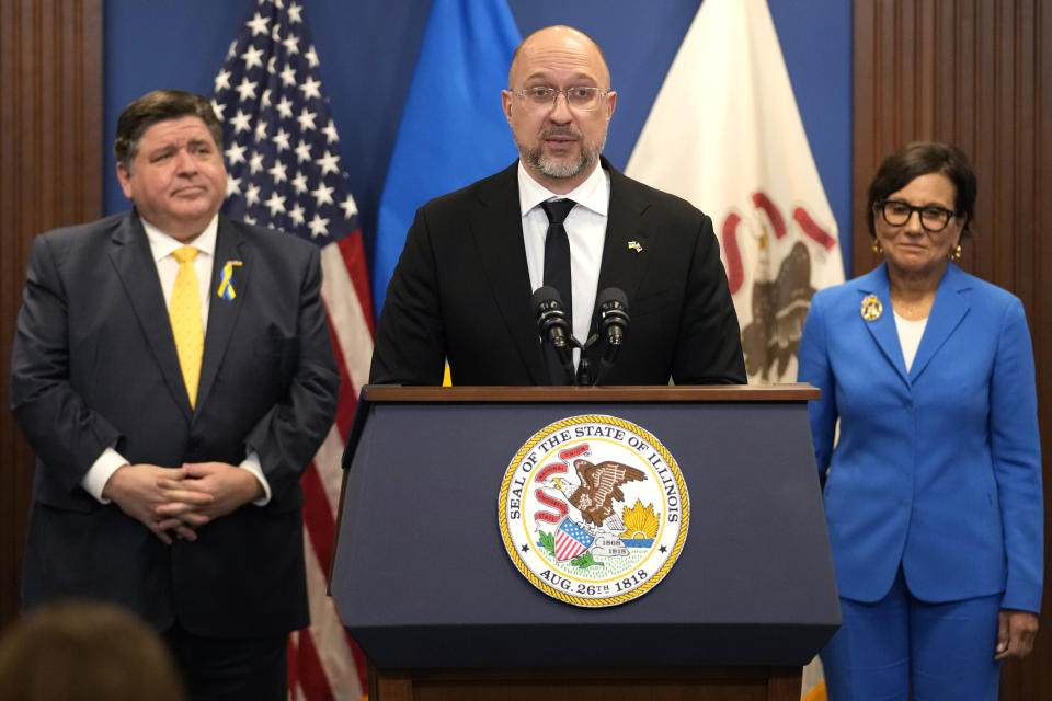 Ukrainian Prime Minister Denys Shmyhal, center, speaks as Illinois Gov. J.B. Pritzker, left, and U.S. Special Representative for Ukraine's Economic Recovery Penny Pritzker listen to him at a news conference in Chicago, Tuesday, April 16, 2024. They delivered joint remarks recognizing the Illinois-Ukraine partnership. (AP Photo/Nam Y. Huh)
