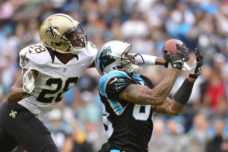 Dec 22, 2013; Charlotte, NC, USA; Carolina Panthers wide receiver Steve Smith (89) catches the ball as New Orleans Saints cornerback Keenan Lewis (28) defends in the first quarter at Bank of America Stadium. Mandatory Credit: Bob Donnan-USA TODAY Sports