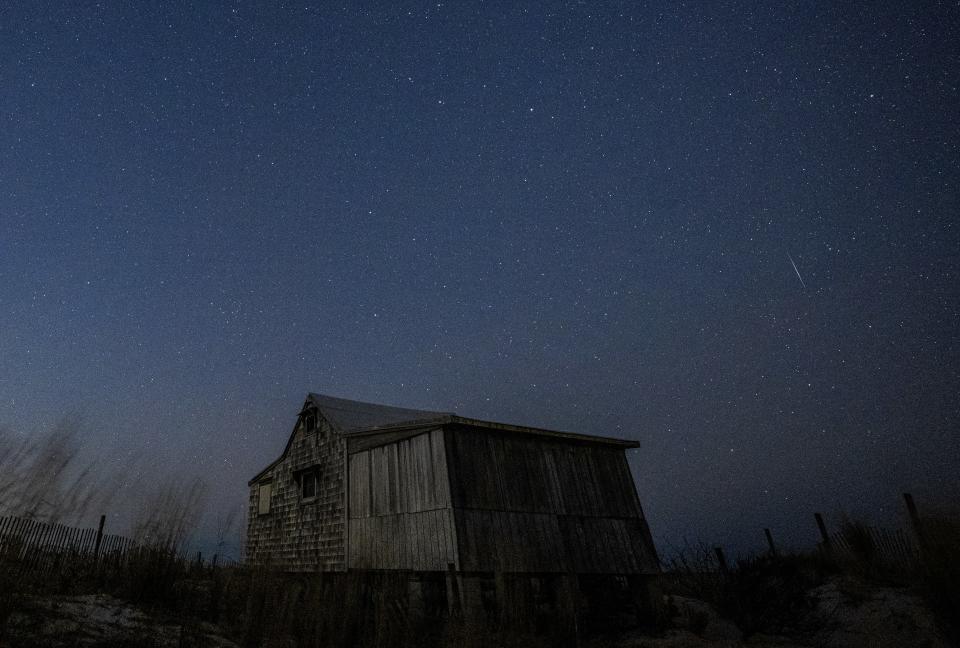 a streak of light in a dark, starry sky