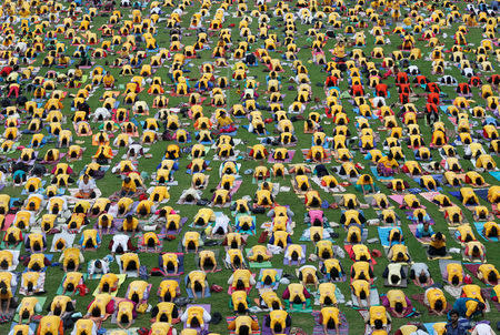 Participants perform yoga at a stadium on International Yoga Day in Bengaluru, India, June 21, 2018. REUTERS/ Abhishek N. Chinnappa