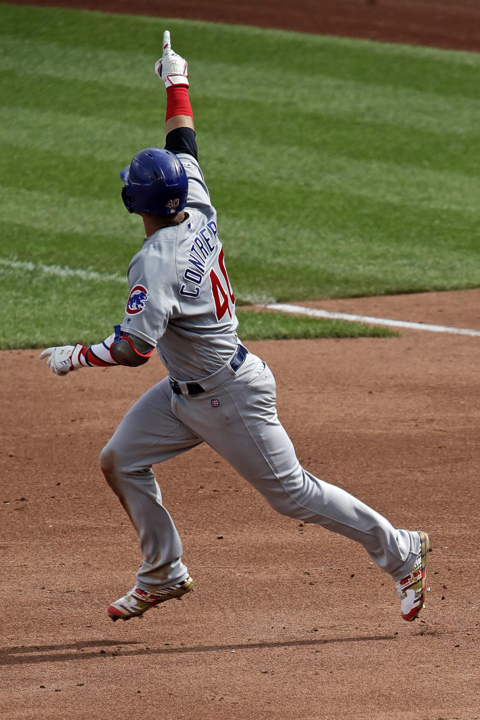 Chicago Cubs' Willson Contreras points to the stands as he rounds first after hitting a two-run home run off Pittsburgh Pirates starting pitcher Jordan Lyles during the third inning of a baseball game in Pittsburgh, Thursday, July 4, 2019. (AP Photo/Gene J. Puskar)