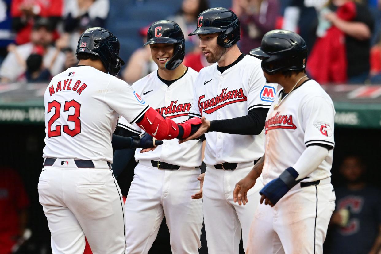 Guardians designated hitter Bo Naylor (23) celebrates with Tyler Freeman, middle left, David Fry, middle right, and Jose Ramirez after hitting a sixth-inning grand slam against the Angels, May 4, 2024, in Cleveland.