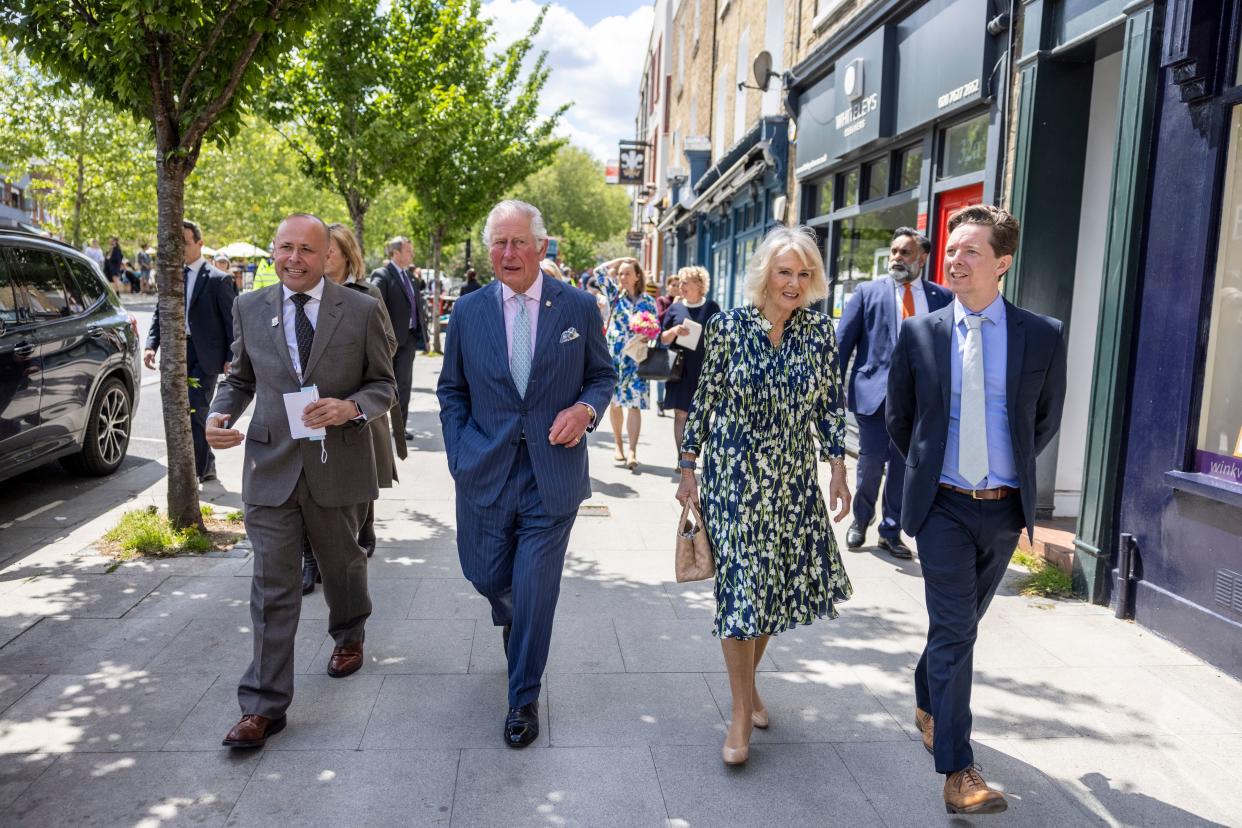 Britain's Prince Charles, Prince of Wales and Britain's Camilla, Duchess of Cornwall walk with Jeremy Keates, Manager of This is Clapham and Christopher Wellbelove, Councillor at Clapham Town Ward during a visit to Clapham Old Town, south London on May 27, 2021. (Photo by Heathcliff O'Malley / POOL / AFP) (Photo by HEATHCLIFF O'MALLEY/POOL/AFP via Getty Images)