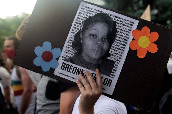 A demonstrator holds a sign with the image of Breonna Taylor, who was fatally shot by Louisville Metro Police officers.