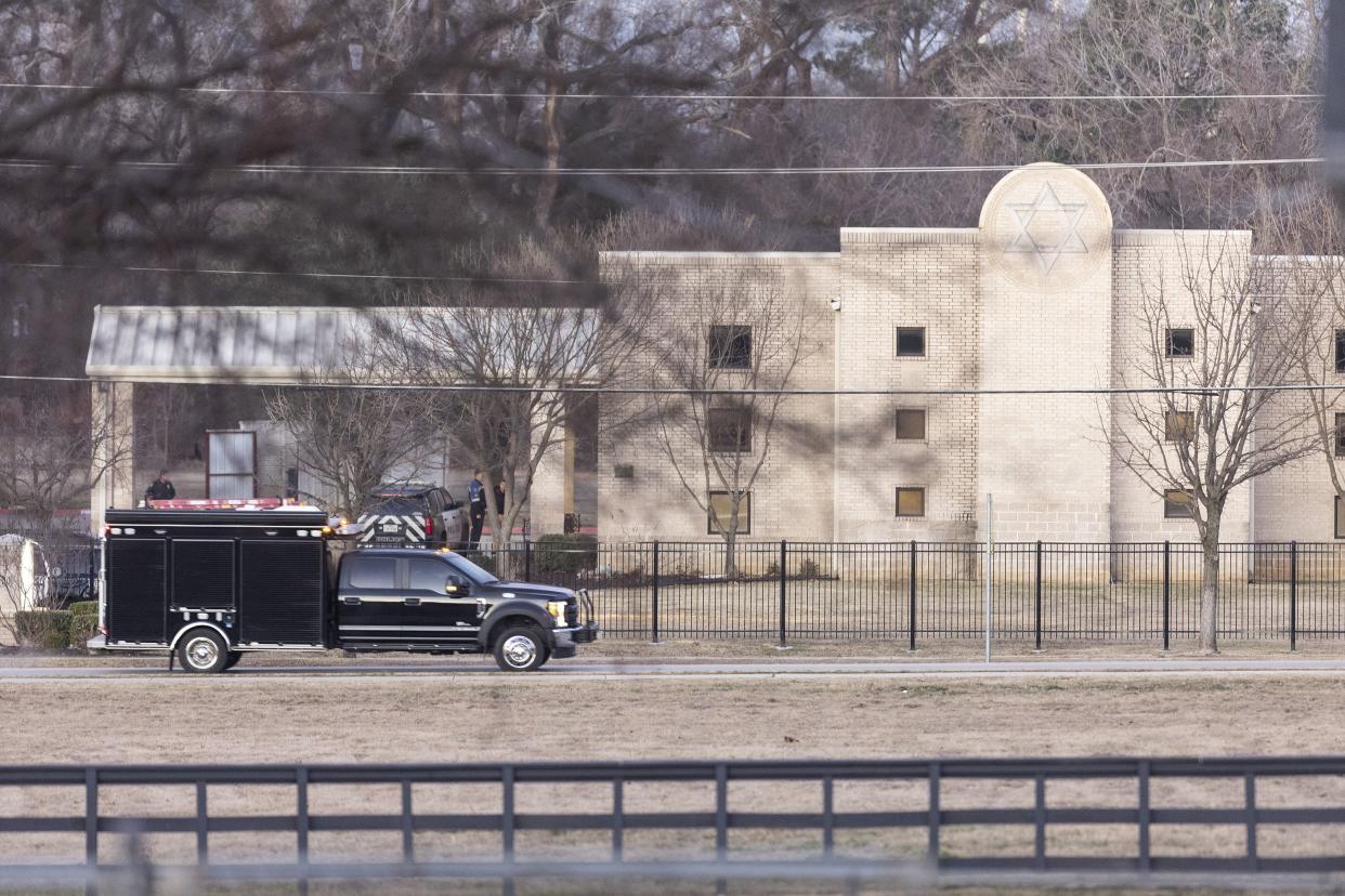 Police stand in front of the Congregation Beth Israel synagogue on Sunday, Jan. 16, 2022, in Colleyville, Texas.