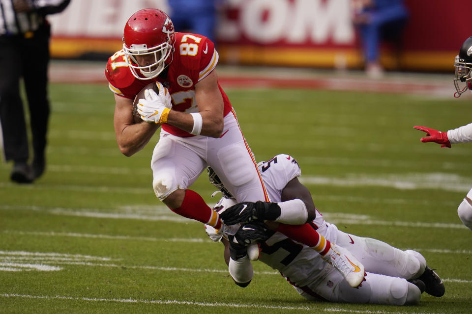 Kansas City Chiefs tight end Travis Kelce is tackled by Atlanta Falcons Foyesade Oluokun during the first half of an NFL football game, Sunday, Dec. 27, 2020, in Kansas City. (AP Photo/Jeff Roberson)