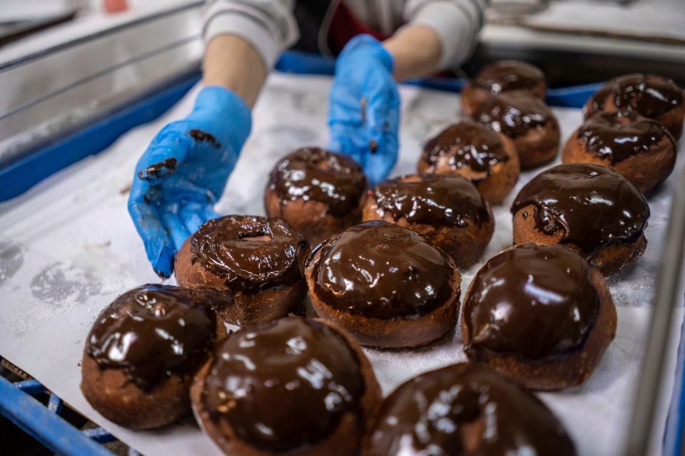 Chocolate paczki are made ahead of Fat Tuesday at Bozek's Markets in Hamtramck on Monday, Feb. 12, 2024.