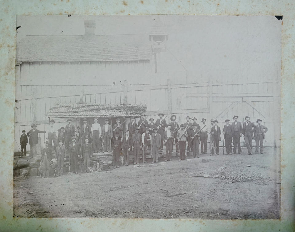 An undated old photograph of the Lone Rock Stockade is shown, May, 28, 2022, in Tracy City, Tenn. The Lone Rock stockage operated for more than 25 years and used prison labor known as convict leasing. The prisoners lived in cramped, unsanitary conditions and risked their lives every day in the iron-making process. (AP Photo/Brynn Anderson)