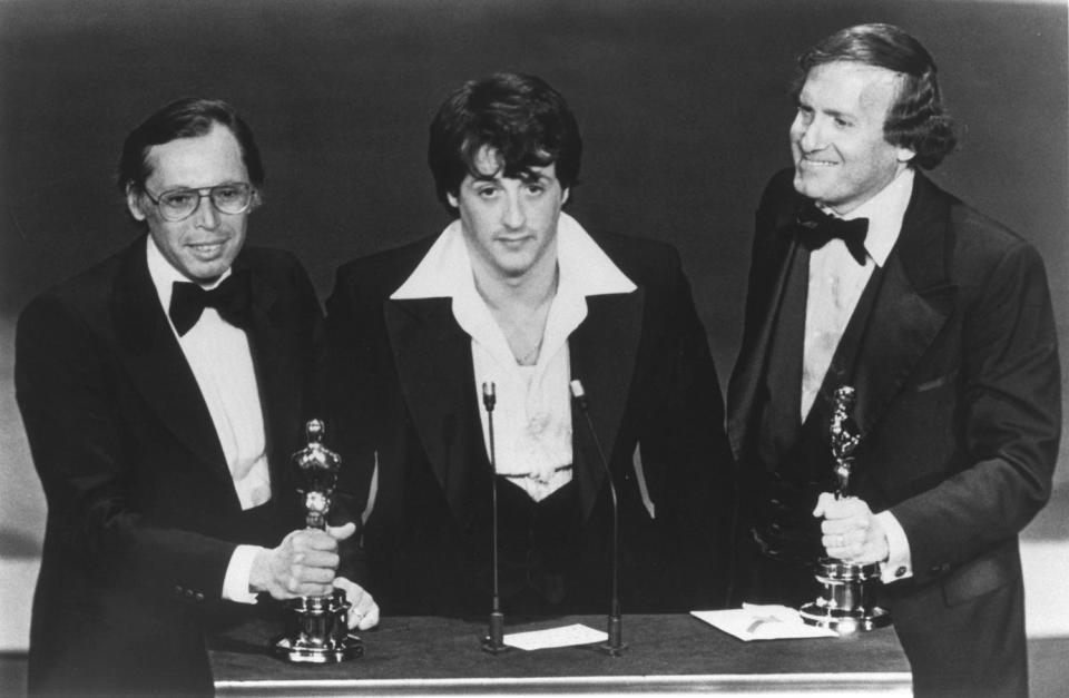 American actor and screenwriter Sylvester Stallone, with producers Irwin Winkler (L), and Robert Chartoff (R), receive the Best Picture award for their movie Rocky during the 49th Academy Awards ceremony. (Photo by Axel Koester/Sygma via Getty Images)