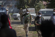 FILE - In this Oct. 6, 2021, file photo, Indian policemen guard during the funeral of Makhan Lal Bindroo, a prominent chemist from Hindu community in Srinagar, Indian controlled Kashmir. A spate of recent killings has rattled Indian-controlled Kashmir, with violence targeting local minority members and Indian civilians from outside the disputed region. The targeted killings have led to widespread unease, particularly among the region’s religious minority Hindus, most of whom fled Kashmir after an anti-India rebellion erupted in 1989. (AP Photo/Mukhtar Khan, File)