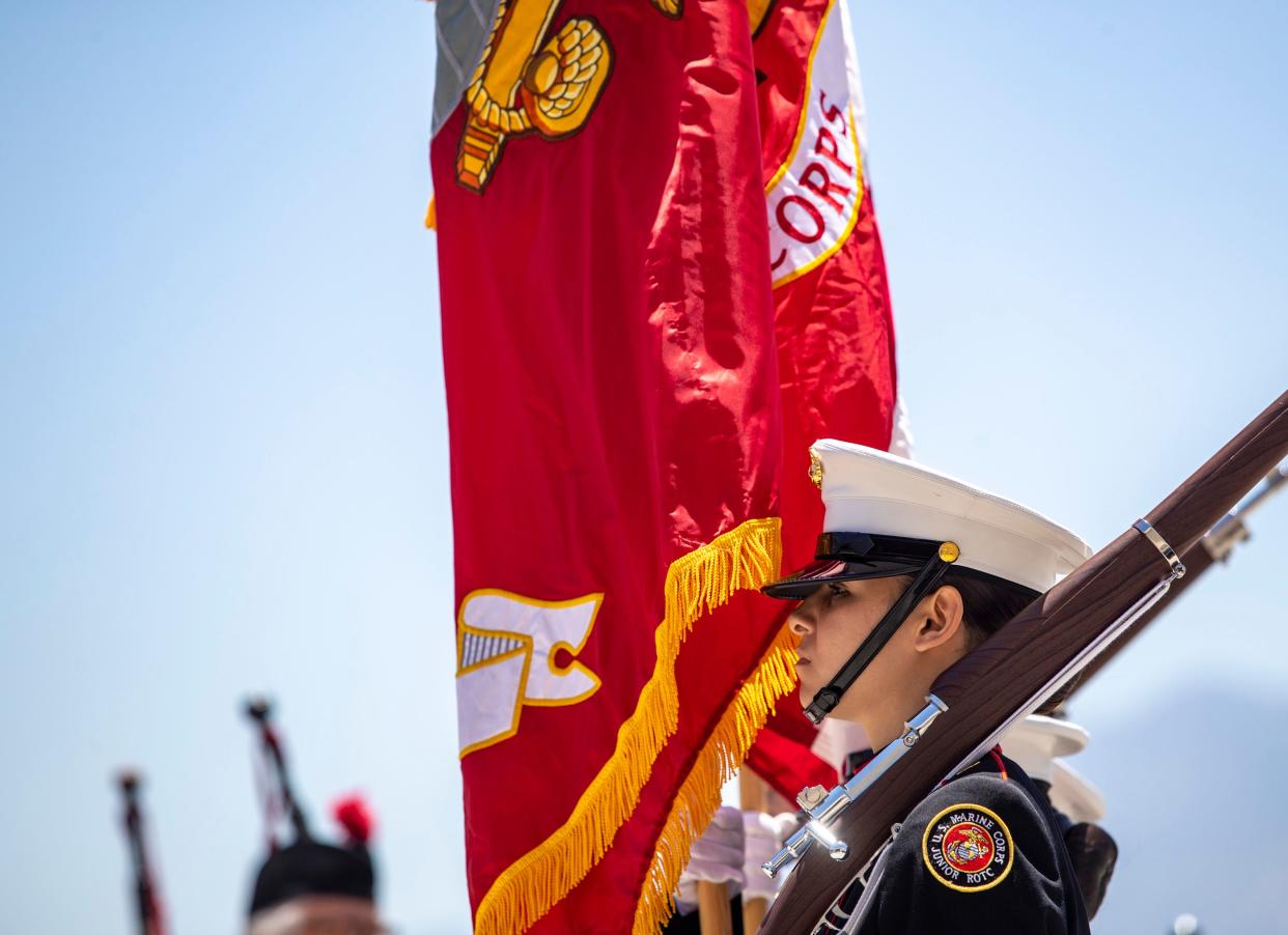 Members of the JROTC Marine Corps color guard present the colors during the Memorial Day Air Fair & Flower Drop at the Palm Springs Air Museum in Palm Springs, Calif., Monday, May 29, 2023. 