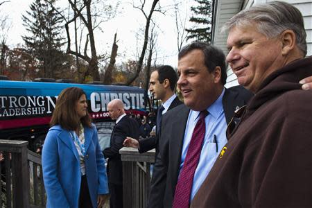 New Jersey Governor Chris Christie (2nd R) greets supporters as he leaves a polling station after casting his vote during the New Jersey governor election in Mendham Township, New Jersey, November 5, 2013. REUTERS/Eduardo Munoz