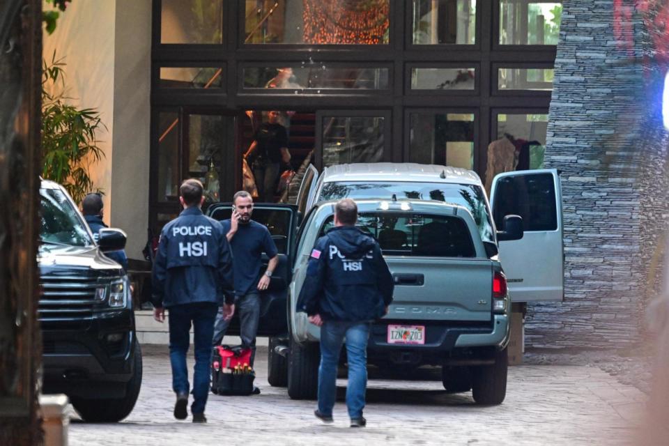 PHOTO: Homeland Security Investigation agents are seen at the entrance of producer and musician Sean 'Diddy' Combs's home at Star Island in Miami Beach, March 25, 2024.  (Giorgio Viera/AFP via Getty Images)