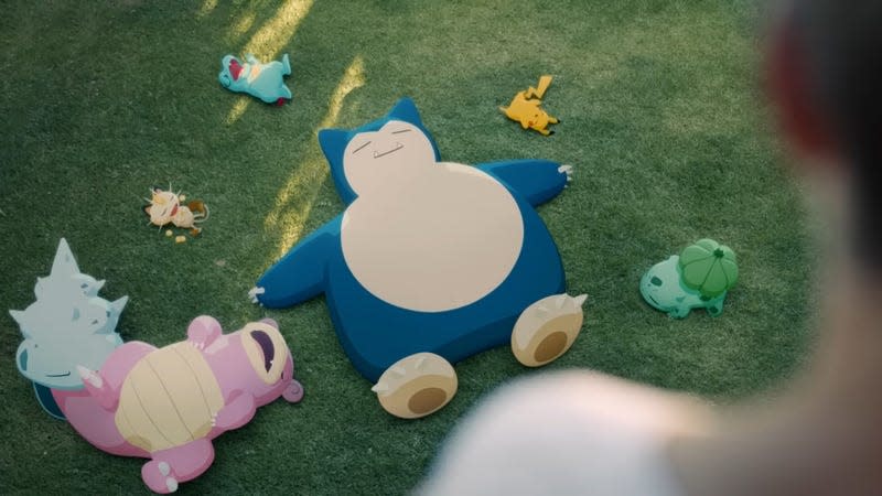 A real human observes Snorlax and sleeping Pokemon.