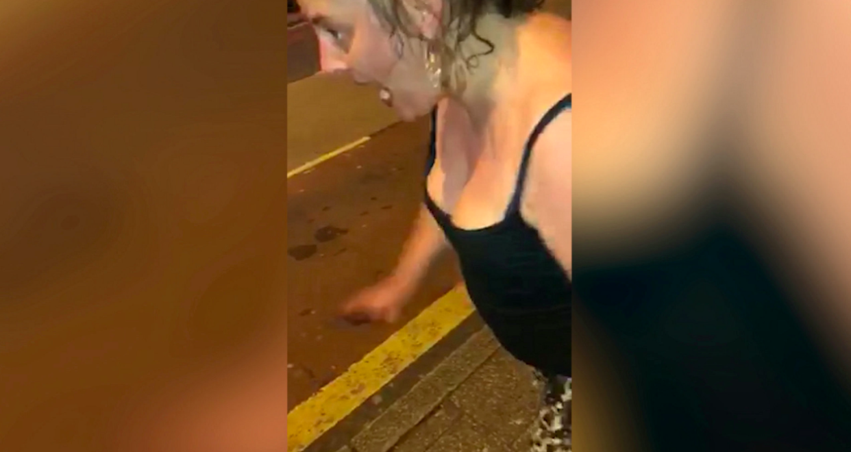 <em>The fuming woman was filmed ranting in the street before delivering a headbutt to the bus stop ad (SWNS)</em>