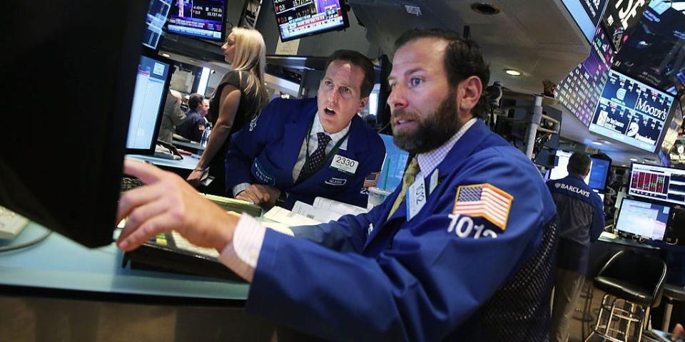 Traders work on the floor of the New York Stock Exchange (NYSE)