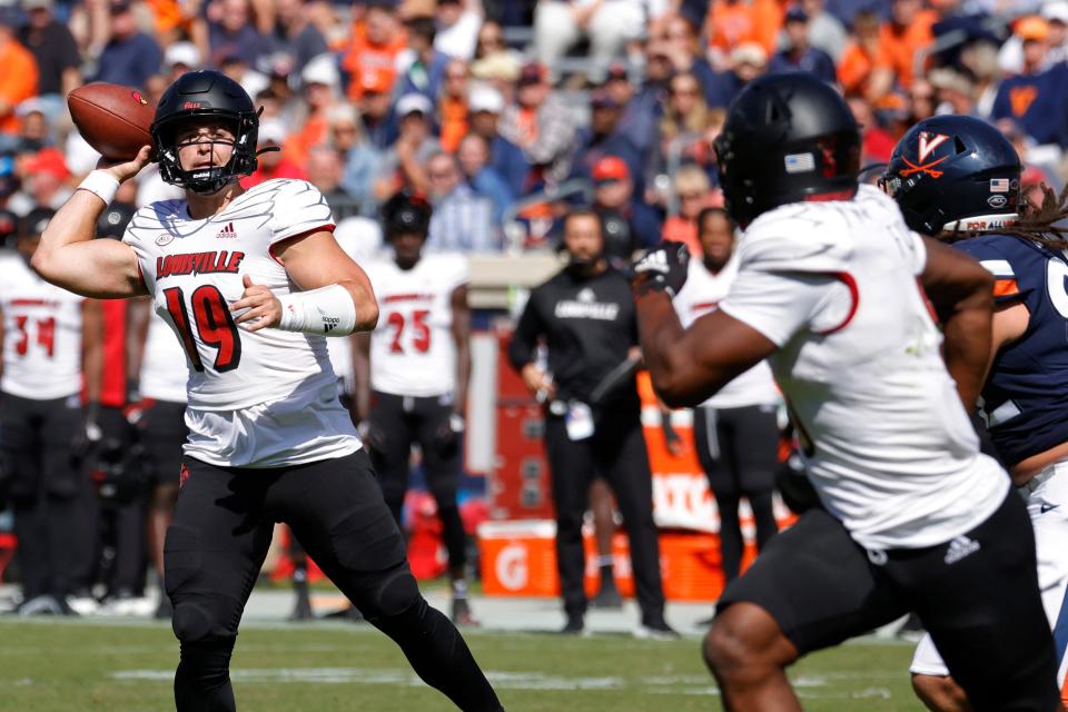 Oct 8, 2022; Charlottesville, Virginia, USA; Louisville Cardinals quarterback Brock Domann (19) passes the ball to Cardinals tight end Marshon Ford (5) as Virginia Cavaliers defensive end Kam Butler (82) defends during the second quarter at Scott Stadium. Mandatory Credit: Geoff Burke-USA TODAY Sports