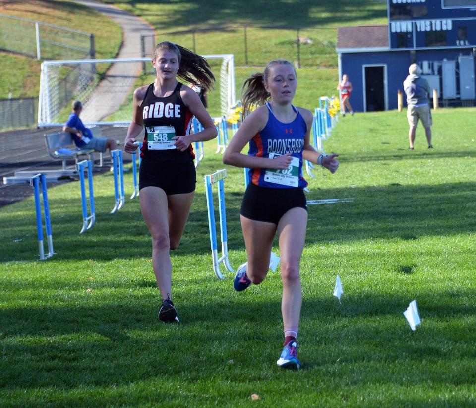 Boonsboro junior Caroline Matthews leads Mountain Ridge senior Mary Delaney at about the halfway point of the Maryland Class 1A West region girls cross country race at Catoctin on Nov. 3, 2022. Matthews finished second to Delaney.