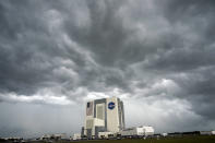 Storm clouds pass over the Vehicle Assembly Building as the SpaceX Falcon 9, with the Crew Dragon spacecraft on top of the rocket, sits on Launch Pad 39-A Wednesday, May 27, 2020, at Kennedy Space Center in Cape Canaveral, Fla. Two astronauts will fly on the SpaceX Demo-2 mission to the International Space Station scheduled for launch Wednesday, weather permitting. (AP Photo/David J. Phillip)