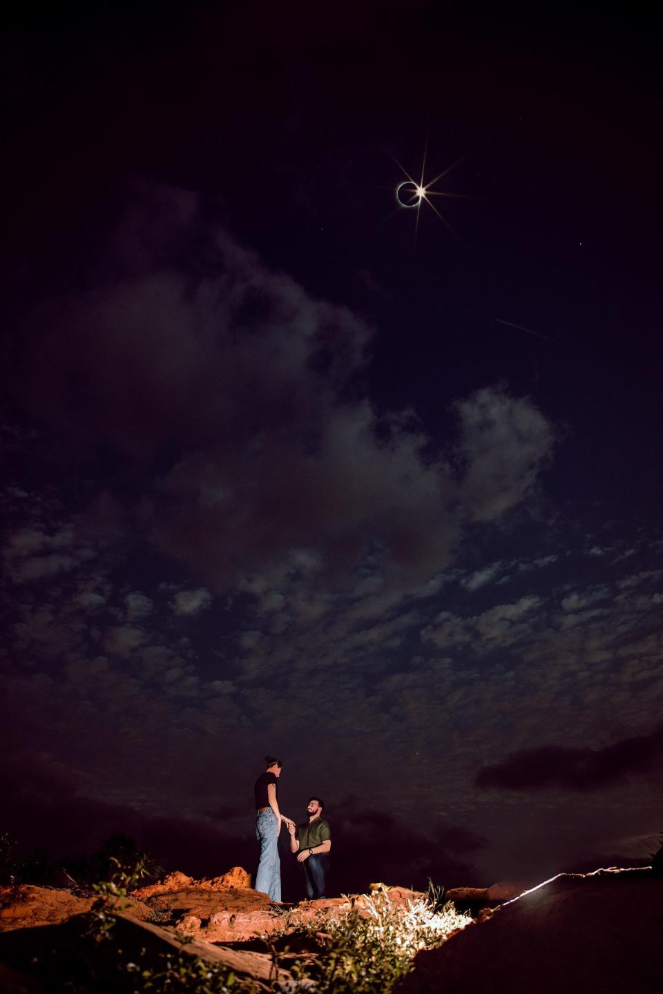 A man proposes to a woman as a total solar eclipse takes place.