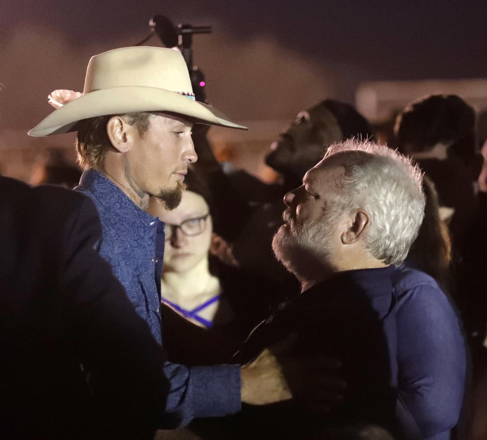 <p>Stephen Willeford, right, hugs Johnnie Langendorff during a vigil for the victims of the First Baptist Church shooting Monday, Nov. 6, 2017, in Sutherland Springs, Texas. Willeford shot suspect Devin Patrick Kelley and Langendorff drove the truck while they chased Kelley. Kelley opened fire inside the church in the small South Texas community on Sunday, killing more than two dozen and injuring others. (Photo: David J. Phillip/AP) </p>