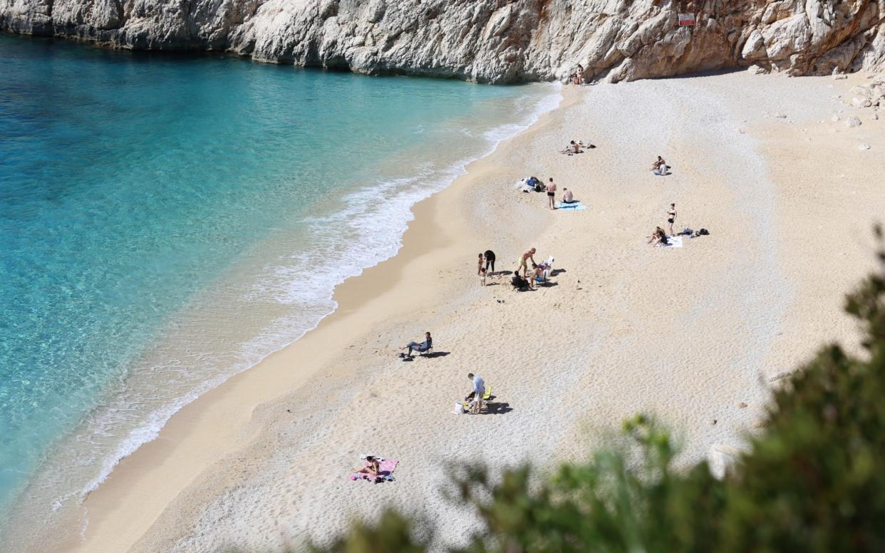 A drone photo shows an aerial view of Kaputas Beach as people enjoy the warm temperature with sea and sand during a sunny day in Kas district of Antalya, Turkey - Anadolu