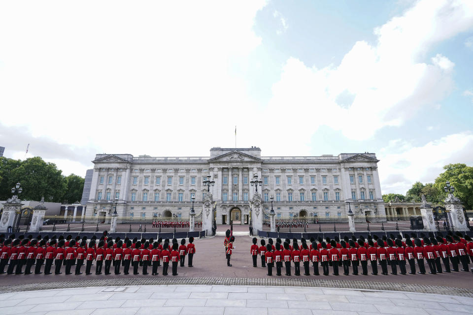 Coldstream Guards stand outside Buckingham Palace prior to the ceremonial procession from the palace to Westminster Hall, London, of the coffin of Queen Elizabeth II, where it will lie in state ahead of her funeral on Monday, Wednesday Sept. 14, 2022. (Ian West/Pool Photo via AP)