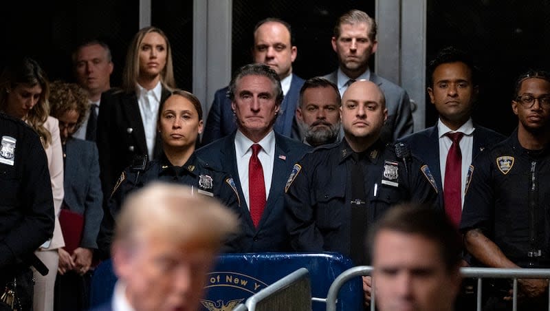 Supporters of former President Donald Trump, including Republican North Dakota Gov. Doug Burgum, center, Republican Rep. Cory Mills, R-Fla., center right, and businessman Vivek Ramaswamy, second from right, listen as Trump speaks after court proceedings ended for the day in his trial at Manhattan criminal court, Tuesday, May 14, 2024, in New York.