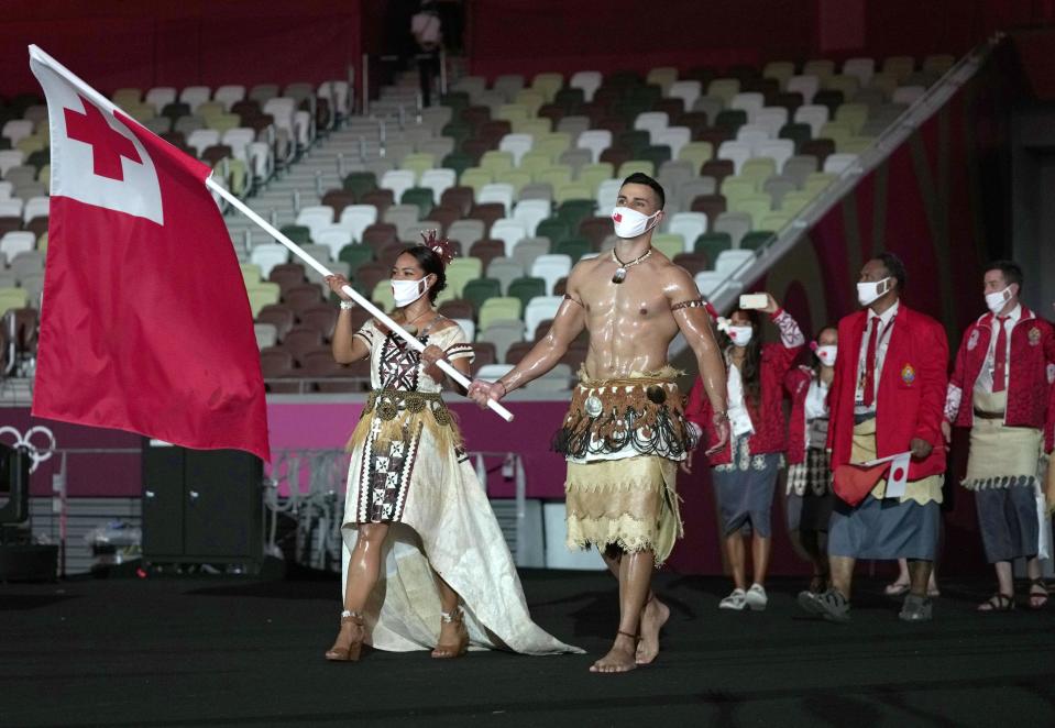 Pita Taufatofua carries the flag of Tonga during the opening ceremony of the Tokyo Olympics. - Credit: Kyodo