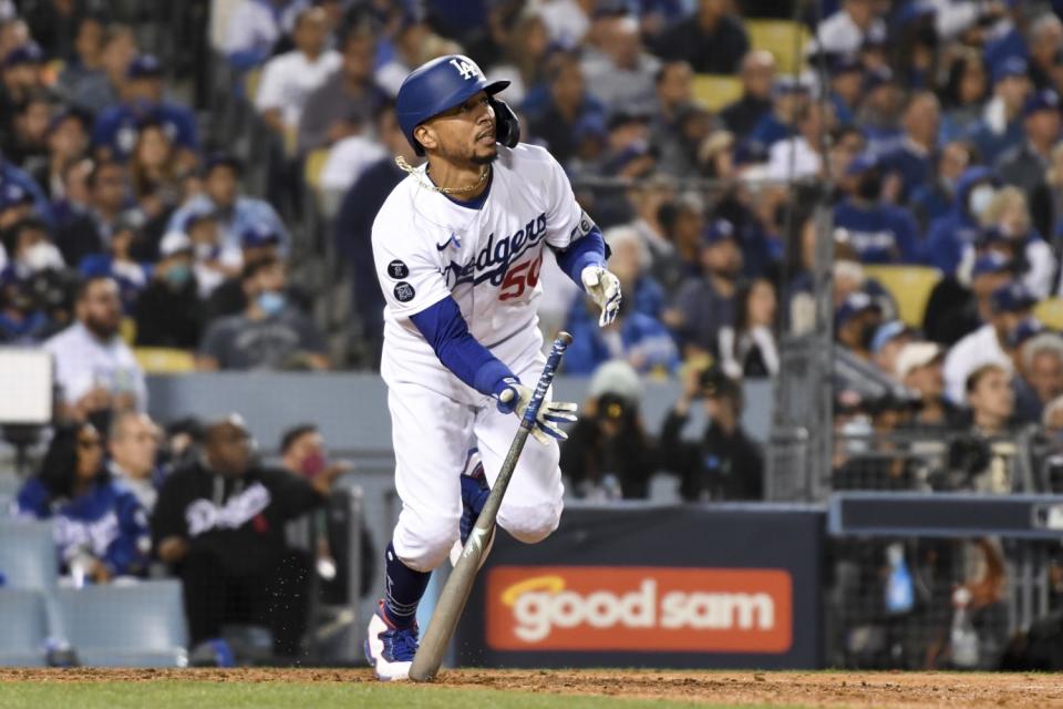 Dodgers' Mookie Betts tosses his bat after hitting a two-run home run.