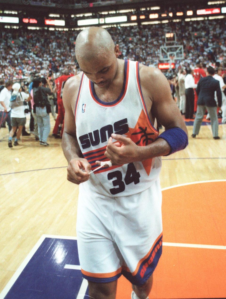 Phoenix Suns' Charles Barkley walks off the court as the Chicago Bulls celebrate in the back ground after winning Game 6 of the 1993 NBA Finals in Phoenix.