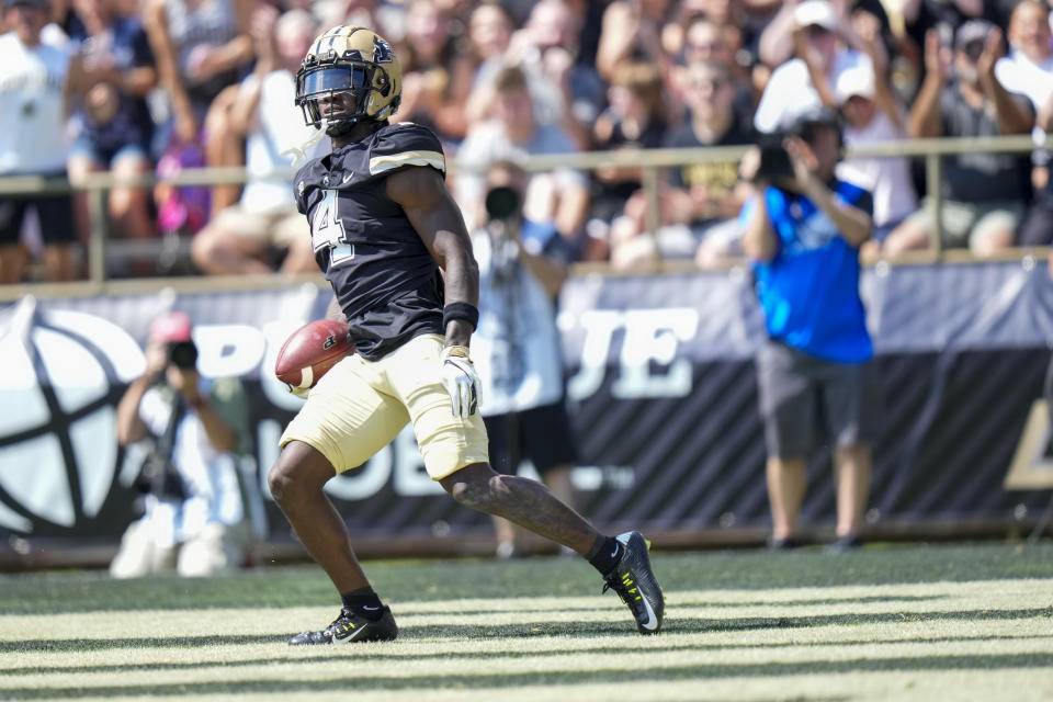 Purdue wide receiver Deion Burks (4) scores a touchdown against Fresno State during the first half of an NCAA college football game in West Lafayette, Ind., Saturday, Sept. 2, 2023. (AP Photo/AJ Mast)