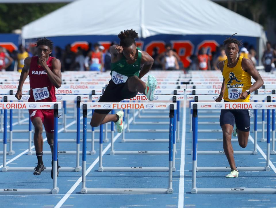 Cyrus Ways, of Nease High School, leaps over the final hurdle on his way to with the Boys 110 Meter Hurdles during the 2022 Pepsi Florida Relays at Percy Beard Track on the University of Florida campus, in Gainesville, April 1, 2022. Ways won with a time of 13.66 seconds.