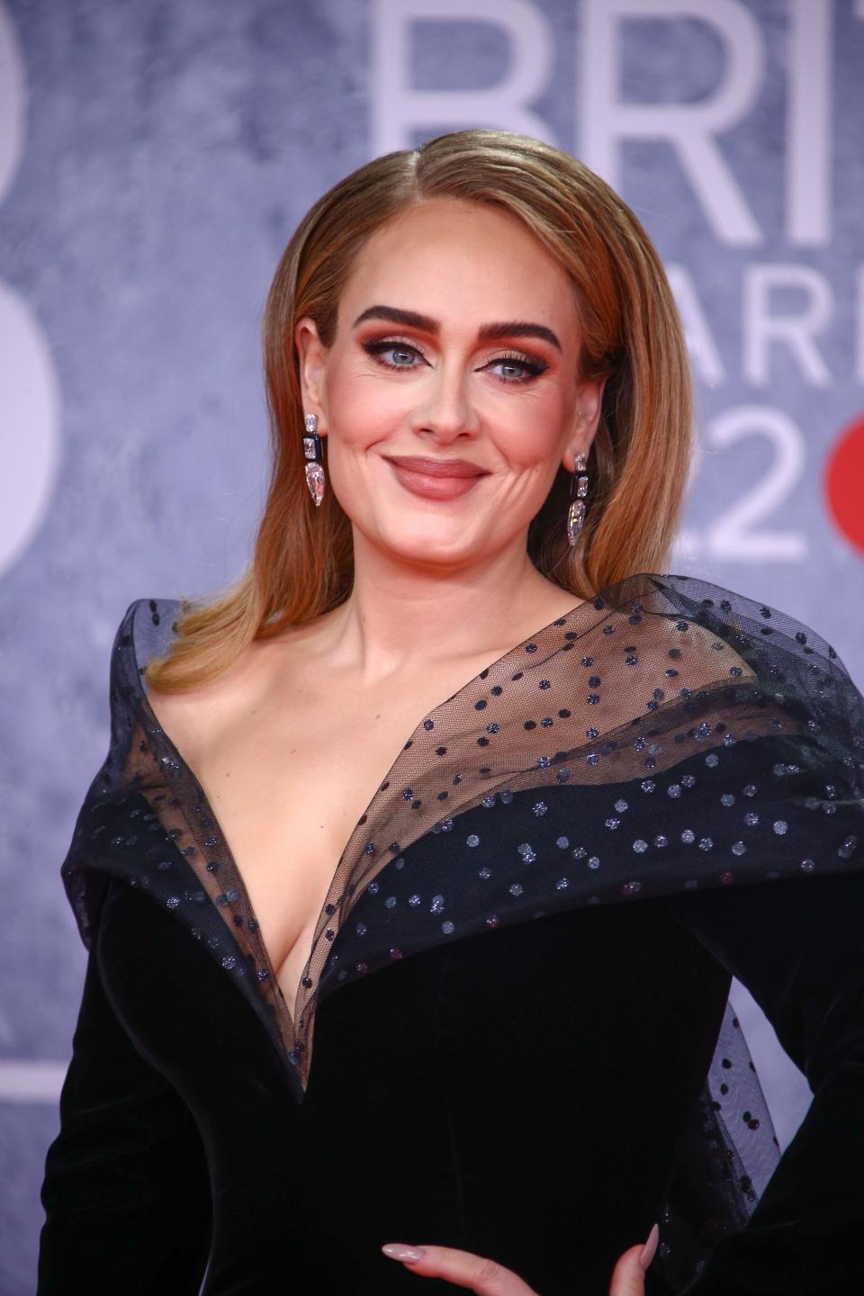 Adele poses for photographers upon arrival at the Brit Awards 2022 in London Tuesday, Feb. 8, 2022.