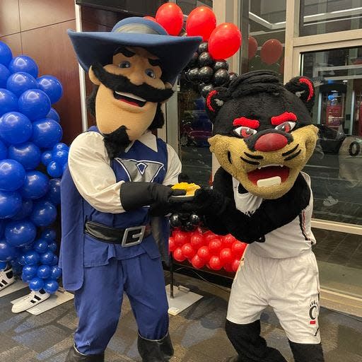 Xavier's Musketeer and Cincinnati's Bearcat compete for Skyline Chili at the Skyline Chili Crosstown Shootout VIP party. This year's game is at Xavier Dec. 9.