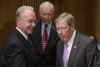 Health and Human Services Secretary-designate, Rep. Tom Price, R-Ga., left, arrives with Senate Finance Committee Chairman Sen. Orrin Hatch, R-Utah, center, and Sen. Johnny Isakson, R-Ga., on Capitol Hill in Washington, Tuesday, Jan. 24, 2017, before the start of his confirmation hearing before the committee. (AP Photo/Andrew Harnik)