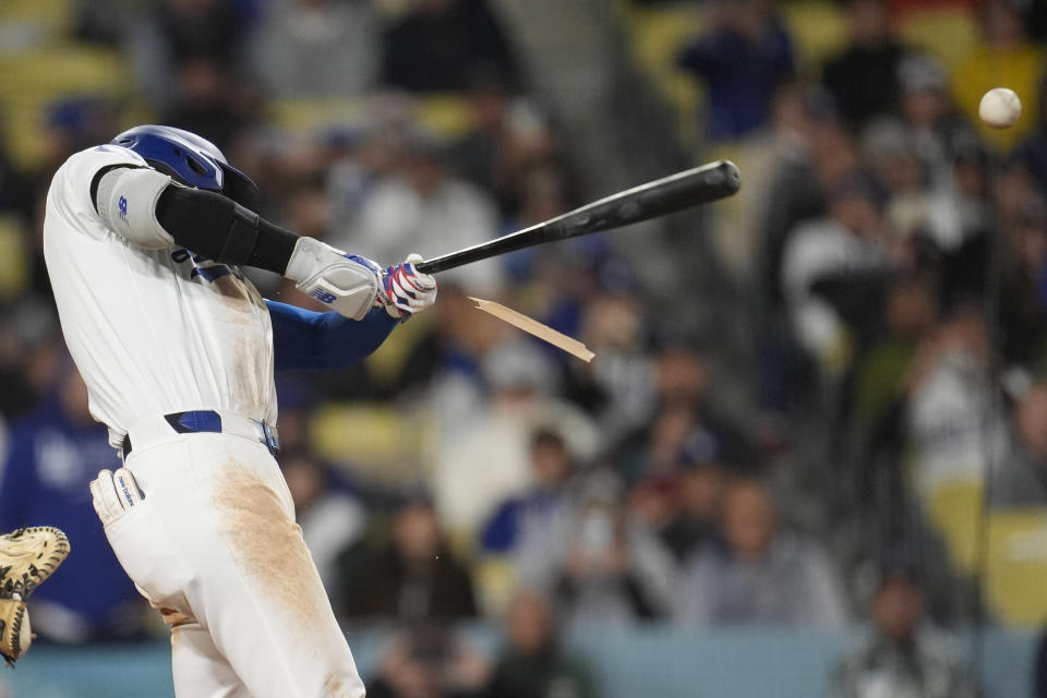 Los Angeles Dodgers' Shohei Ohtani breaks his bat as he lines out to third base during the fourth inning of the team's baseball game against the San Diego Padres on Saturday, April 13, 2024, in Los Angeles. (AP Photo/Marcio Jose Sanchez)
