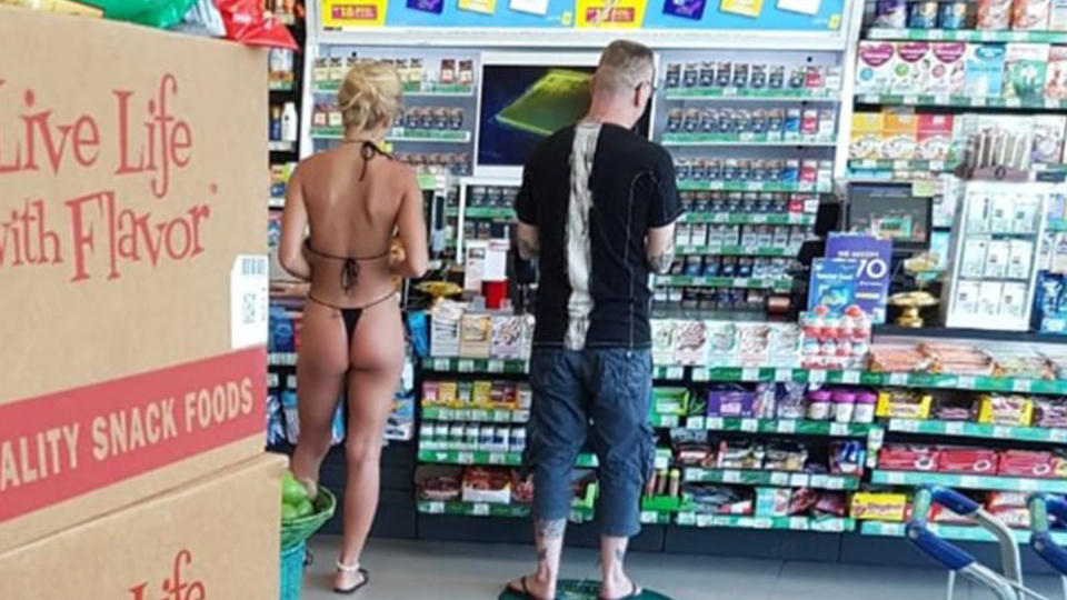 A photo of a woman wearing the small bikini in a convenience store in Bali.