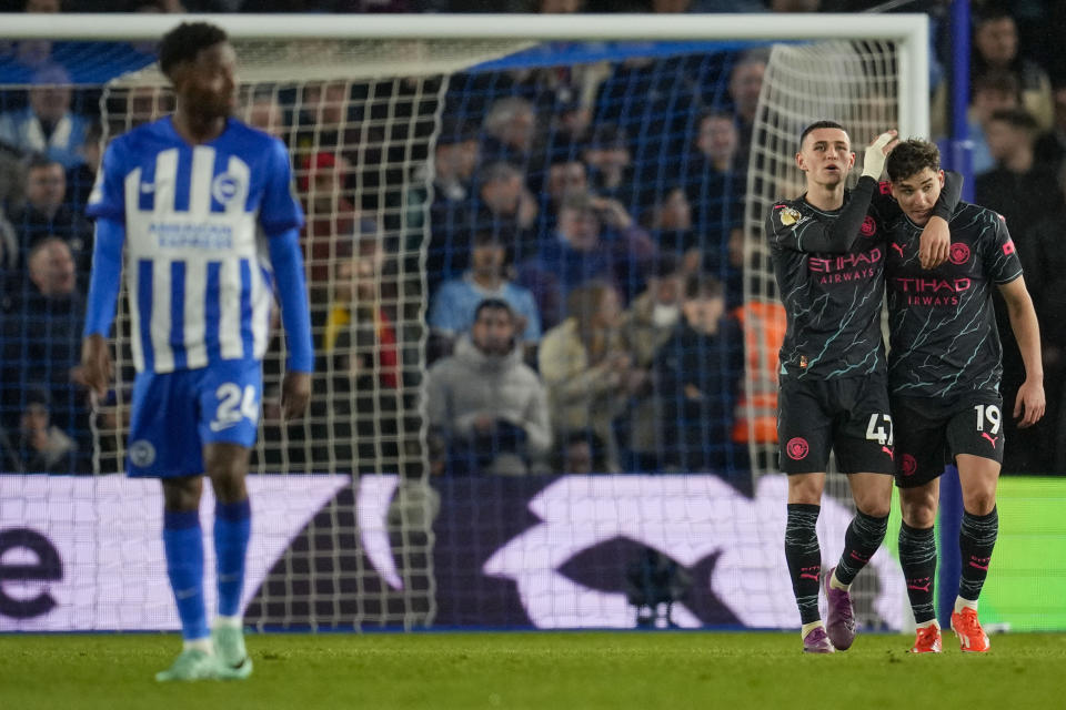 Manchester City's Julian Alvarez, right, celebrates with Manchester City's Phil Foden after scoring his side's fourth goal during the English Premier League soccer match between Brighton and Manchester City at the Falmer Stadium in Brighton, England, Thursday, April 25, 2024. (AP Photo/Kin Cheung)