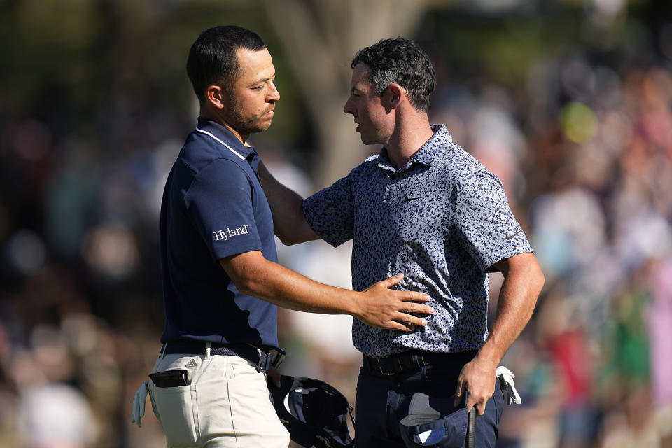 Rory McIlroy, of Northern Ireland, right, is congratulated by Xander Schauffele, left, after their quarterfinal round at the Dell Technologies Match Play Championship golf tournament in Austin, Texas, Saturday, March 25, 2023. McIlroy won the match. (AP Photo/Eric Gay)