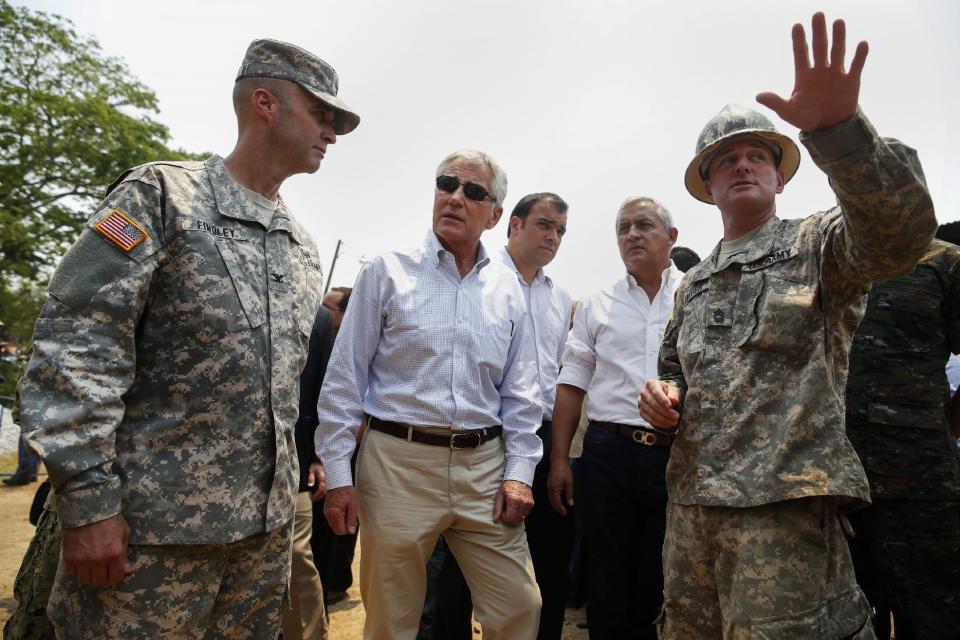 Defense Secretary Chuck Hagel and Guatemalan President Otto Perez Molina visit a U.S and Guatemalan school building base in Los Limones, Guatemala, Friday, April 25, 2014. (AP Photo/Shannon Stapleton, Pool)