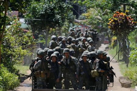 Philippines army soldiers ride in trucks into the fighting zone as government troops continue their assault against insurgents from the Maute group in Marawi City, Philippines June 28, 2017. REUTERS/Jorge Silva