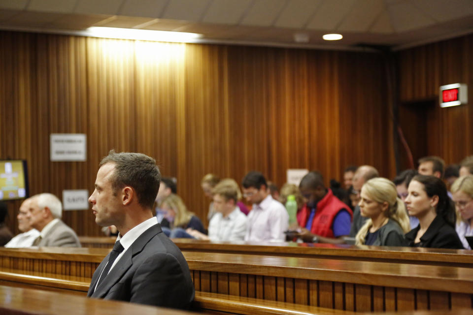Oscar Pistorius, front left, listens to cross questioning in court during his trial at the high court in Pretoria, South Africa, Friday, March 7, 2014. Pistorius is charged with murder for the shooting death of his girlfriend, Steenkamp, on Valentines Day in 2013. (AP Photo/Schalk van Zuydam, Pool)