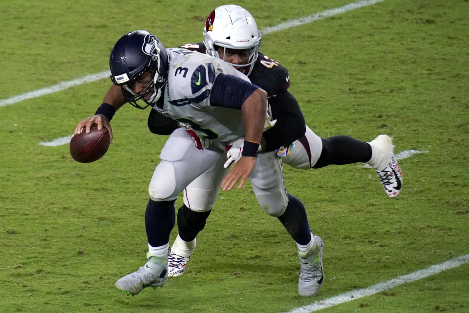 Seattle Seahawks quarterback Russell Wilson (3) is hit by Arizona Cardinals outside linebacker Haason Reddick (43) during the second half of an NFL football game, Sunday, Oct. 25, 2020, in Glendale, Ariz. (AP Photo/Ross D. Franklin)