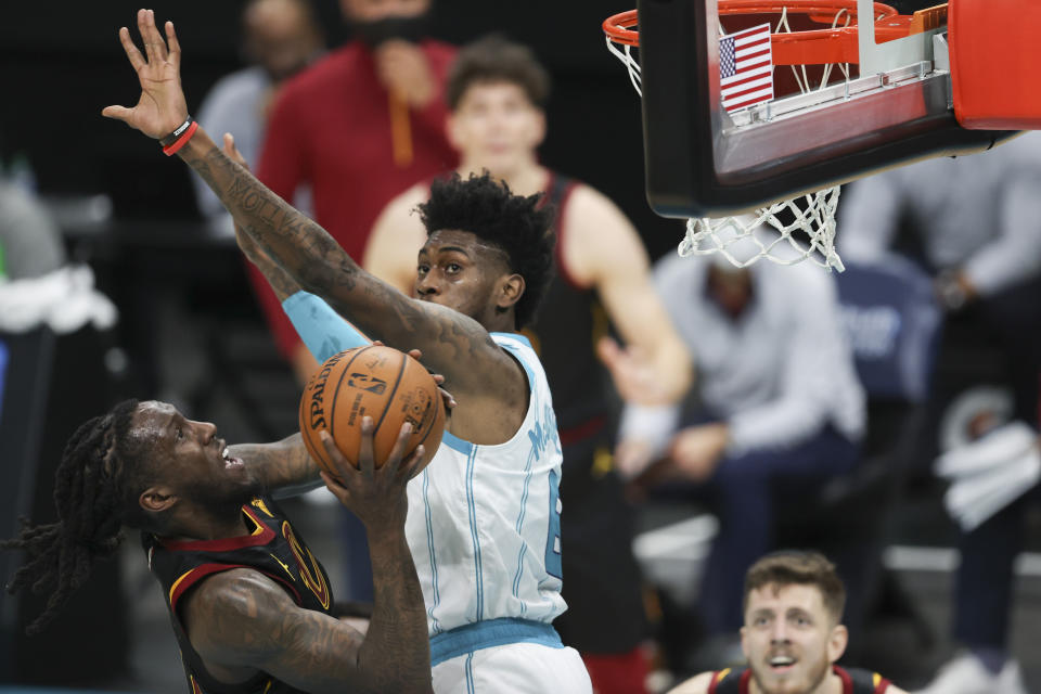 Cleveland Cavaliers forward Taurean Prince, left, shoots against Charlotte Hornets forward Jalen McDaniels during the second quarter of an NBA basketball game in Charlotte, N.C., Wednesday, April 14, 2021. (AP Photo/Nell Redmond)