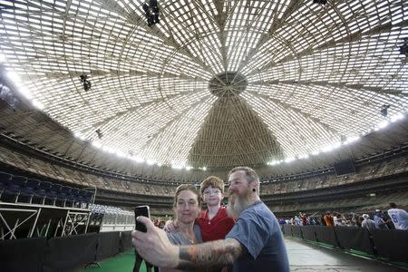 (From left) Tiffany Almquist, 38, Samuel Almquist, 7 and Adam Almquist, 39, pose for a selfie as people celebrate the 50th anniversary of the Astrodome stadium in Houston, Texas, April 9, 2015. REUTERS/Daniel Kramer