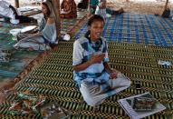 Maam Samba Mbow, 22, from Baye Fall community, sits during an interview with journalists in Mbacke Kadjior