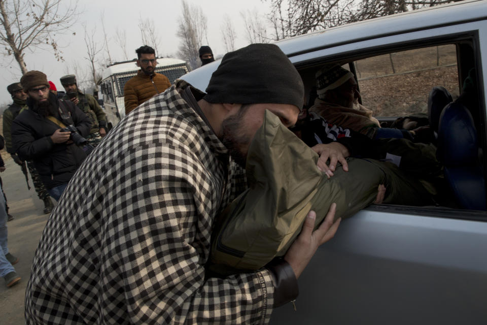 An unidentified Kashmiri man kisses the body of Nadeem Sofi, a local rebel after collecting it from an army camp in Tral, south of Srinagar, Indian controlled Kashmir, Saturday, Dec. 22, 2018. A gunbattle between Indian troops and Kashmiri rebels early Saturday left six militants dead and triggered a new round of anti-India protests in the disputed Himalayan region. (AP Photo/Dar Yasin)