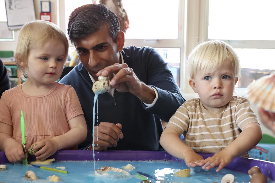 FILE - British Prime Minister Rishi Sunak plays with children as he visits the Imagination Childcare children's centre during a Conservative general election campaign event in Swindon, Britain, Friday, June 7, 2024. (Phil Noble/Pool Photo via AP, File)