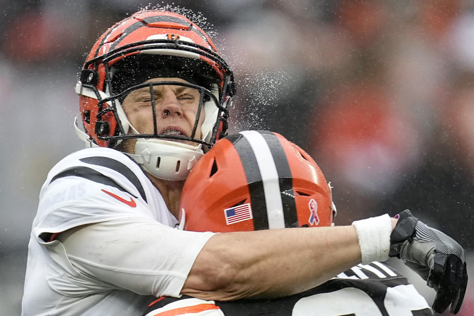 Cincinnati Bengals quarterback Joe Burrow, left, is hit by Cleveland Browns safety Grant Delpit, during the second half of an NFL football game Sunday, Sept. 10, 2023, in Cleveland. (AP Photo/Sue Ogrocki)